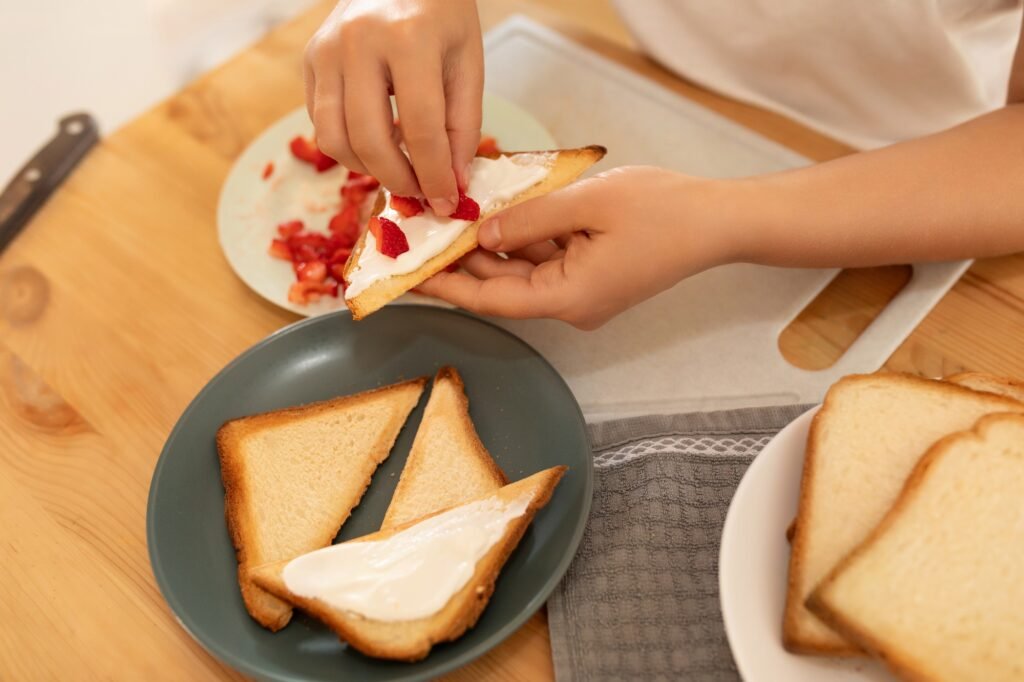 a woman makes a sandwich for a snack in the kitchen