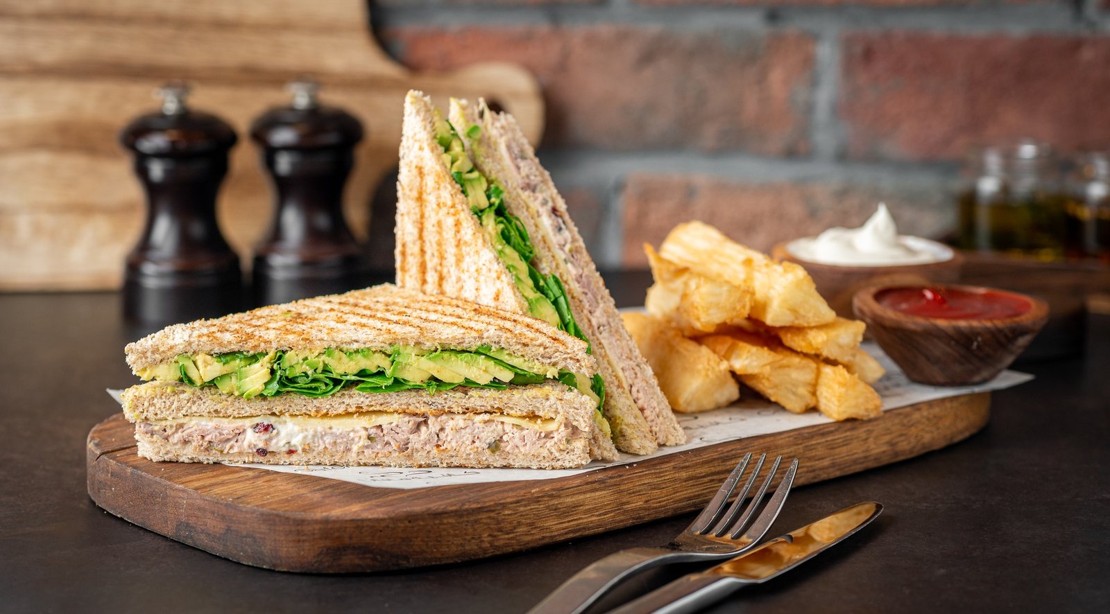 Closeup of a sandwich with chips and veggies